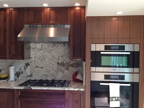 Walnut kitchen with wall ovens