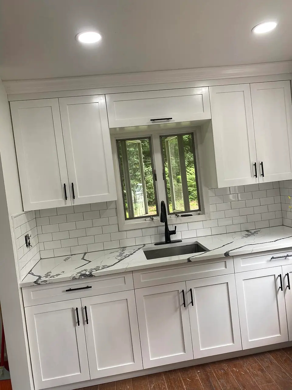 White kitchen cabinets with black hardware by Jupiter Cabinets